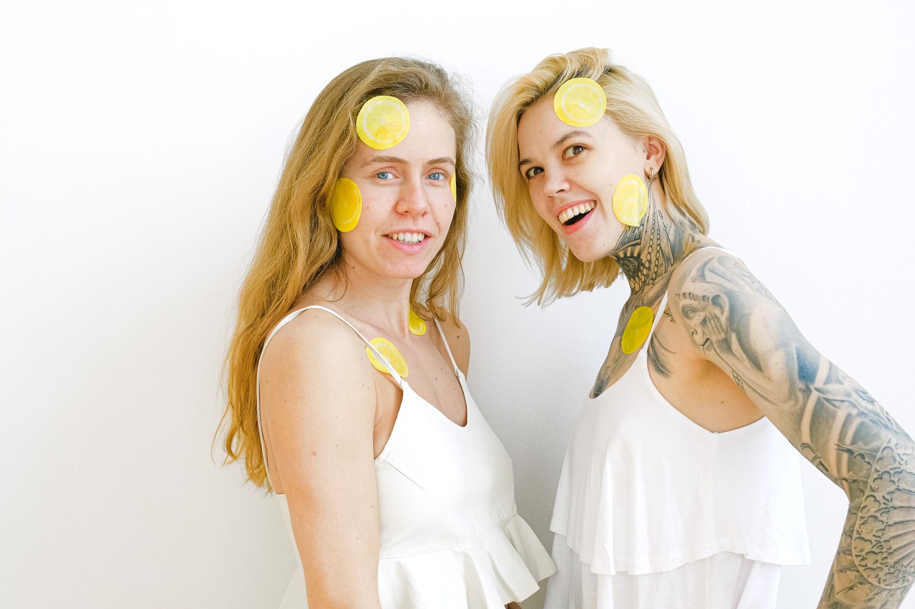 Hand holding a lemon on soft pink background, symbolizing tenderness and recovery