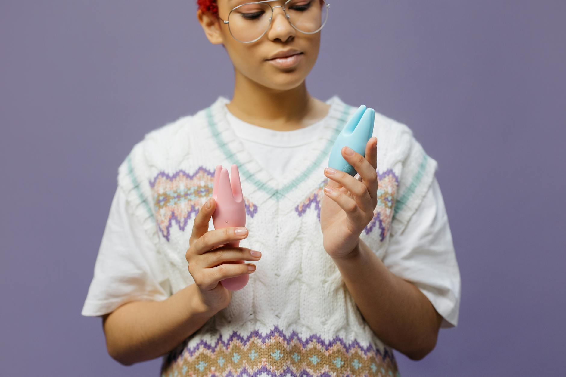 Woman holding colorful vibrators, representing pleasure alternatives when medication affects arousal
